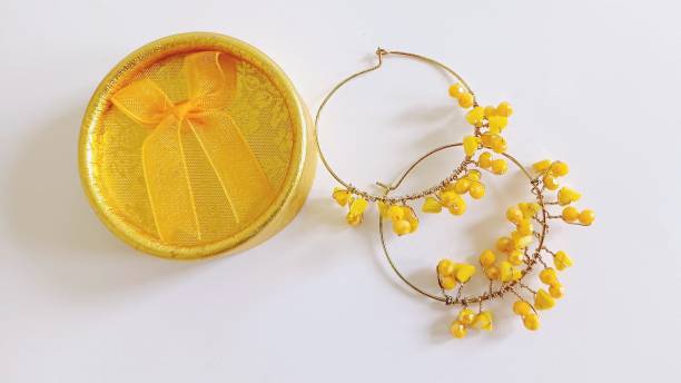 istock yellow hoop earrings on a white background 2156004966