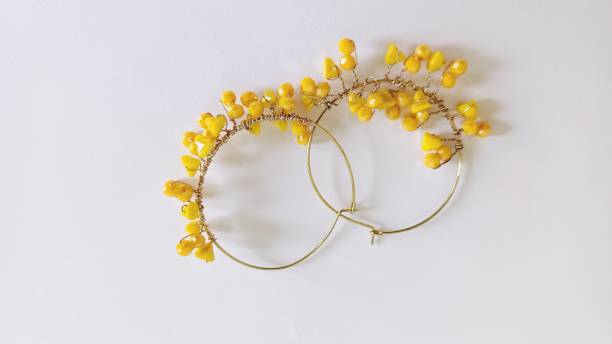 yellow hoop earrings on a white background