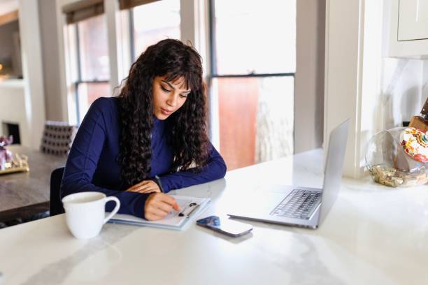 istock Woman doing paperwork at home 2156005992