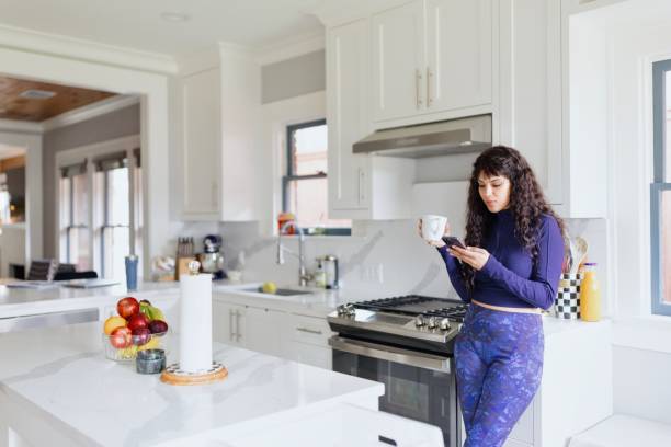istock Woman surfing the net in the kitchen 2156006045