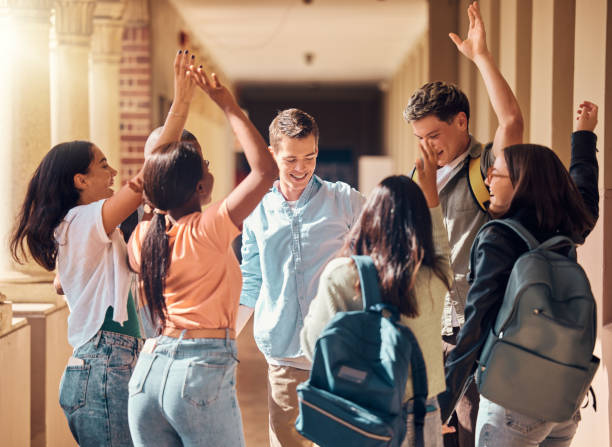 istock Students, happy and dancing to celebrate on campus together for project success, interracial education and goal achievement. Diversity, group of college friends and study celebration or dance hands 2156006438