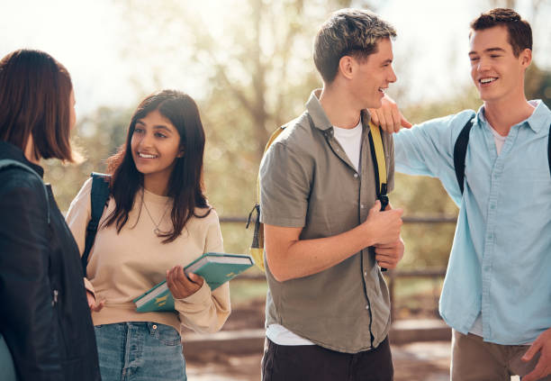 istock Student, friends and conversation for social discussion, break or interval at the university. Happy students with smile enjoying communication, socializing or discussing education or scholarship talk 2156006477