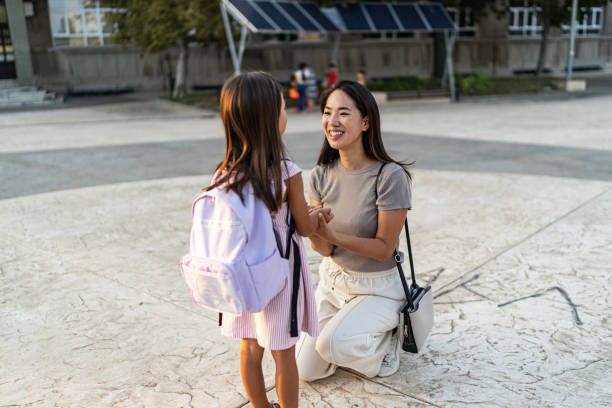 istock School child taking lunch box from her mother 2156006524