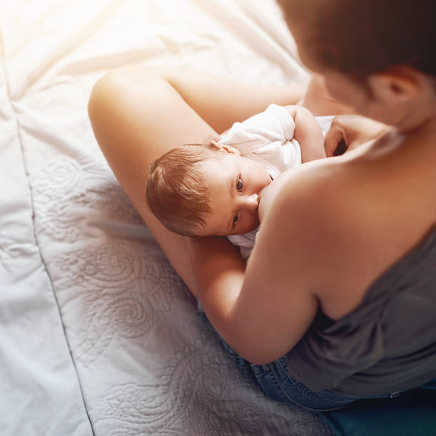 Breastfeeding comes with many benefits mamá, niño y lactancia materna en la cama para el desarrollo, el crecimiento, la nutrición o la salud digestiva en el dormitorio. amor, vista superior y mujer con niño recién nacido para leche natural, bienestar o vinculación en el hogar