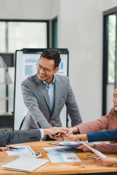 istock Diverse group of office colleagues laughing together during a meeting. 2156013449