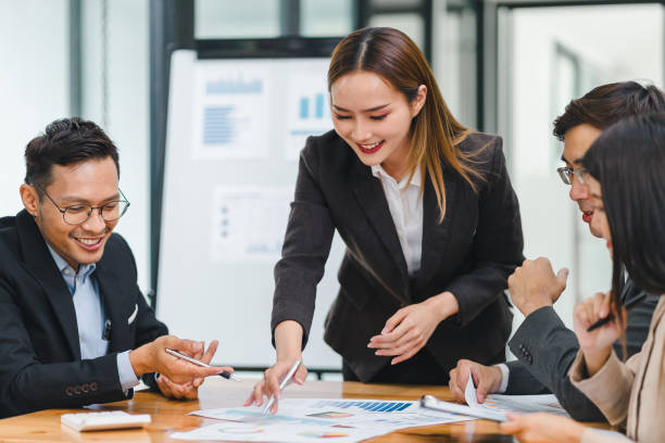 istock Business professionals review data during meeting in modern office. 2156013510