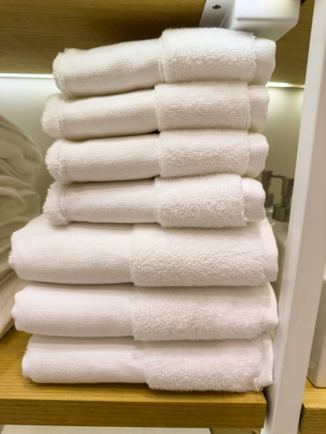 istock Light colored towels are stacked on shelves in a store 2156014194