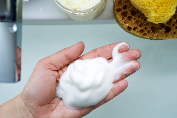 istock Foam cleanser in female hands over the sink. 2156014328