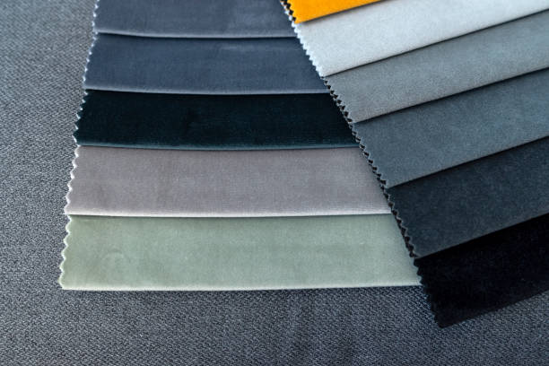 istock upholstery fabric samples on grey sofa, concept of renovation 2156015799