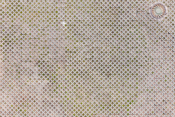 Urban parking ground with concrete tiling and a manhole cover, background photo texture, top view