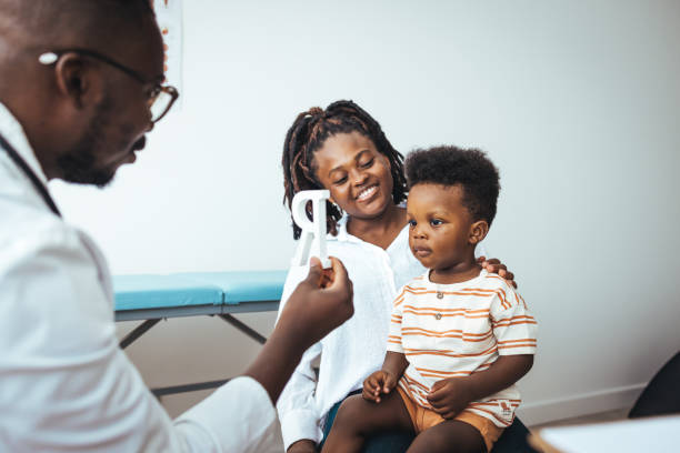 istock Young Black Child with Mother at Pediatric Appointment 2156017436