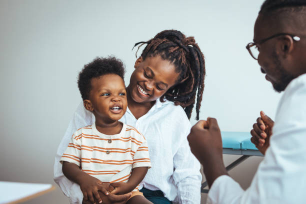 Pediatric Checkup for Smiling Boy with Mother and Doctor
