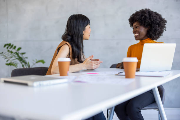 istock Diverse Businesswomen Engaged in Discussion at Office Workspace 2156017643