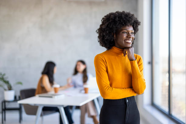 istock Smiling Professional Black Woman in Sunny Office Space 2156017671