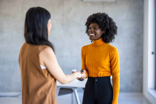 istock Diverse Businesswomen Engaging in Firm Handshake 2156017677