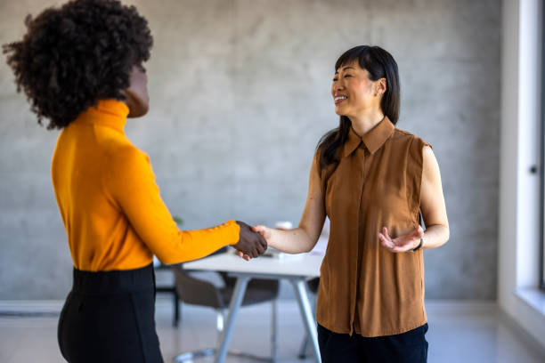 istock Diverse Businesswomen Handshake in Office Setting 2156017682