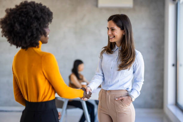 istock Diverse Businesswomen Handshake in Office Setting 2156017687