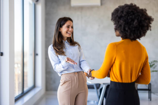 istock Diverse Businesswomen Handshake in Office Setting 2156017691