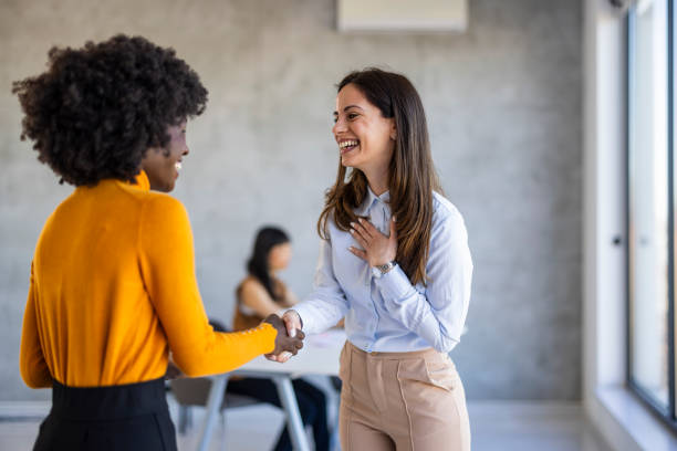 istock Diverse Businesswomen Handshake in Office Setting 2156017717