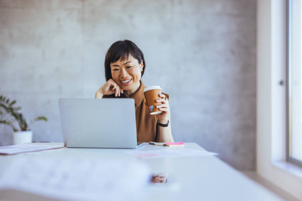 istock Joyful Asian Businesswoman Working with Laptop 2156017725
