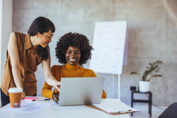 istock Diverse Businesswomen Engage in Teamwork at Office 2156017750