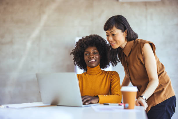 istock Diverse Businesswomen Collaborate at Office Desk 2156017761