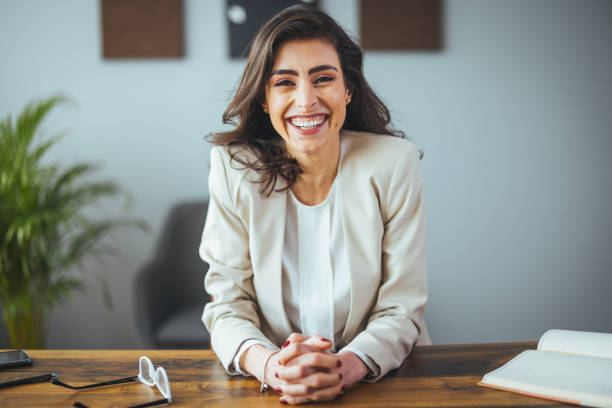 istock Professional Businesswoman Smiling in Office Setting 2156017890