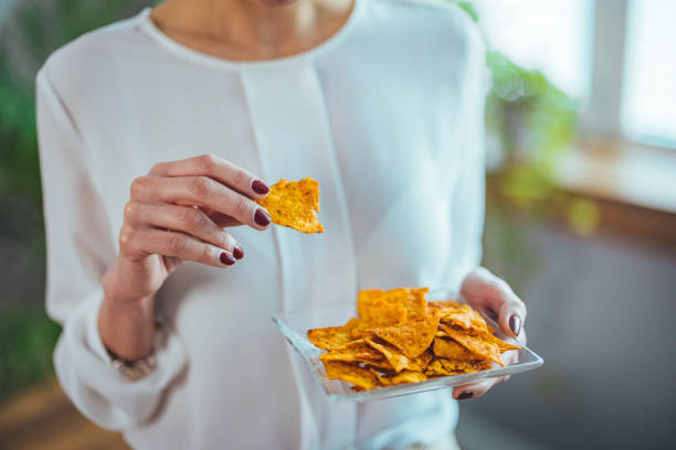 istock Professional Woman Relishing Snack Break in Workspace 2156017982