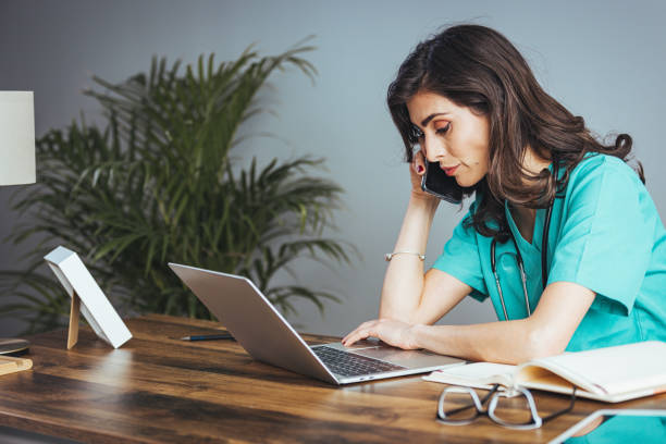 istock Focused Caucasian Female Doctor Handling Office Tasks 2156018014