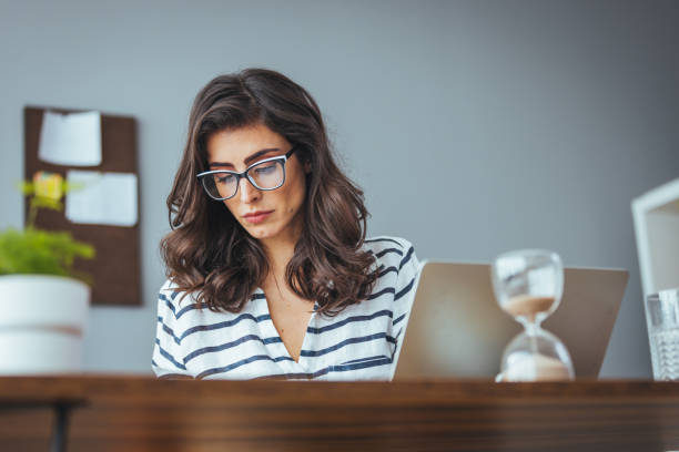 istock Focused Businesswoman Working on Laptop in Modern Office 2156018079
