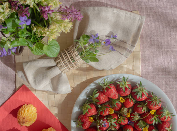 istock Spring forest flowers, strawberries and napkin on the table 2156018139