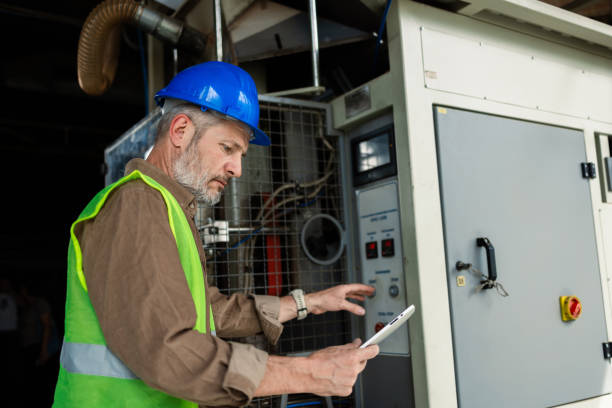 istock Manager checking the work of the electric supply system at the warehouse 2156018681