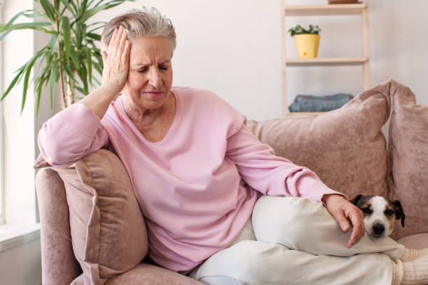 istock middle aged lady looking away sit alone at home feel anxious lonely, sad 2156018792