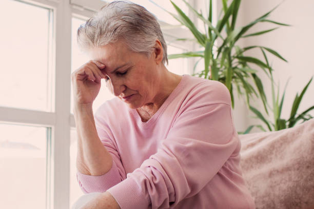 istock middle aged lady looking away sit alone at home feel anxious lonely, sad 2156018796