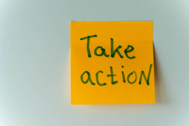 istock A yellow reminder sticker with the message Take action written in green 2156020760