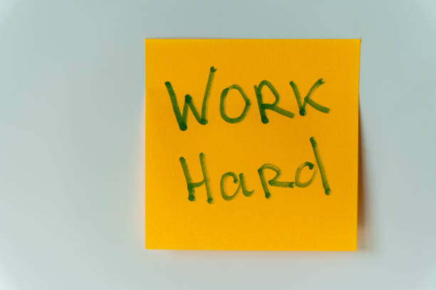 istock A yellow sticky note with green handwriting that reads Work Hard 2156020775