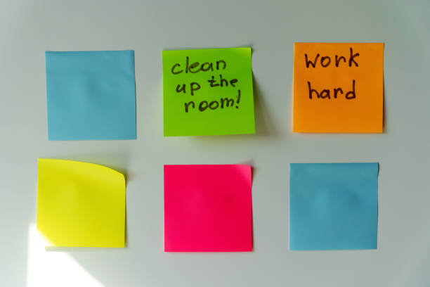 istock Six colorful sticky notes with handwritten reminders on a white surface.  clean the room, work hard 2156020780