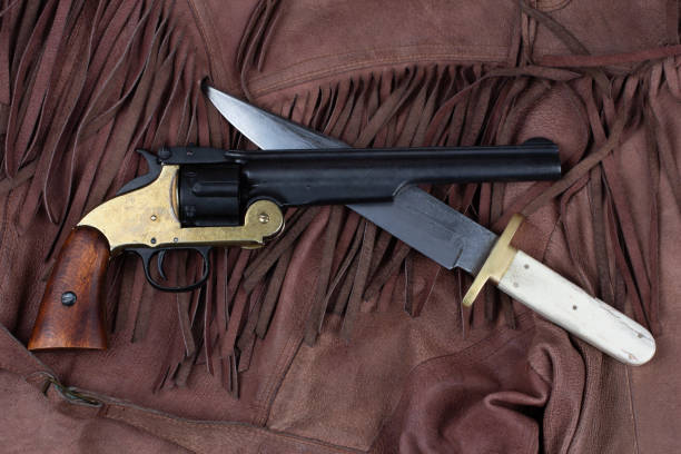 istock Old West Revolver with bowie knife on leather jacket 2156023927