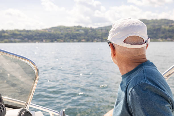 istock Boat captain Steering a Boat and Looking at Shoreline 2156024494