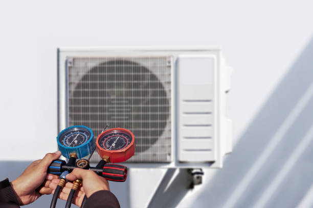 istock Air conditioning, HVAC service technician using gauges to check refrigerant and add refrigerant. 2156027240