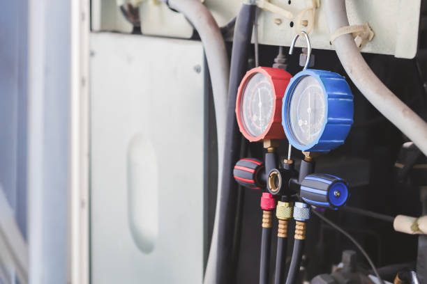 istock Air conditioning, HVAC service technician using gauges to check refrigerant and add refrigerant. 2156027242
