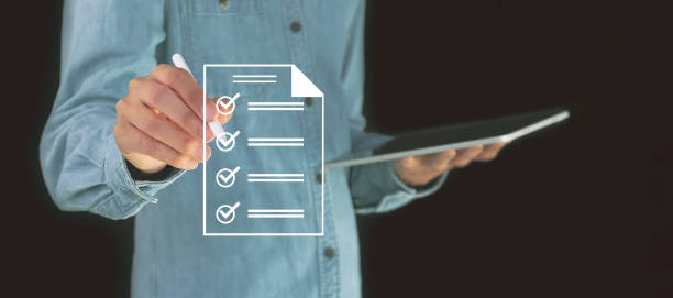 istock checklist Complete the performance review digital form checklist.business people using evaluation questionnaire evaluation 2156027282