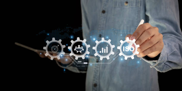 istock Businessman ISO symbol showing quality assurance on virtual screen 2156027285