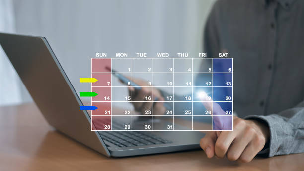 istock Businessman sets agenda on calendar as appointment planning concept. 2156027306