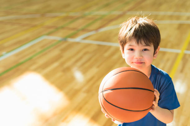 istock Balls going into basketball goal 2156028863