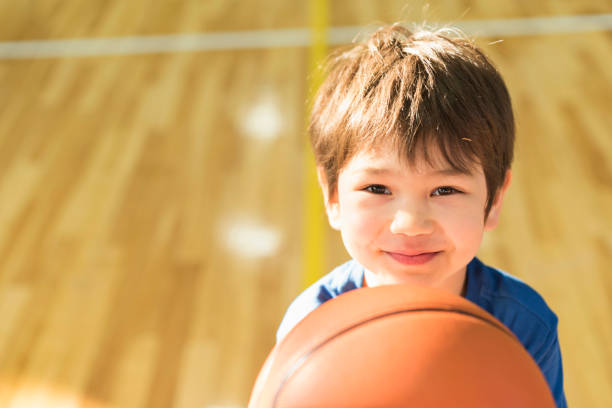 istock Balls going into basketball goal 2156028920