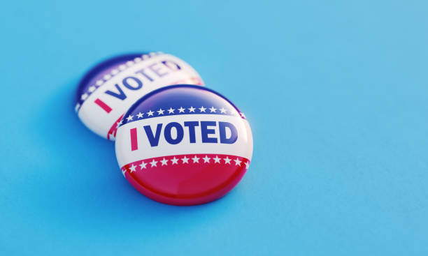 istock I Voted Printed Badges On Blue Background 2156030503