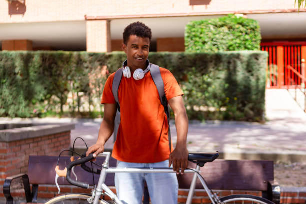 istock Young delivery man smiling with his bicycle 2156031790