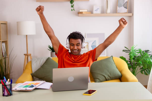 istock Young designer celebrating success working from home 2156032423