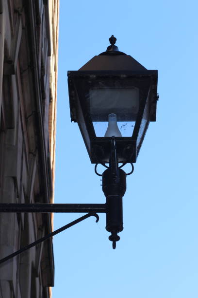 istock Black light fixture mounted on a stone building facade 2156035445
